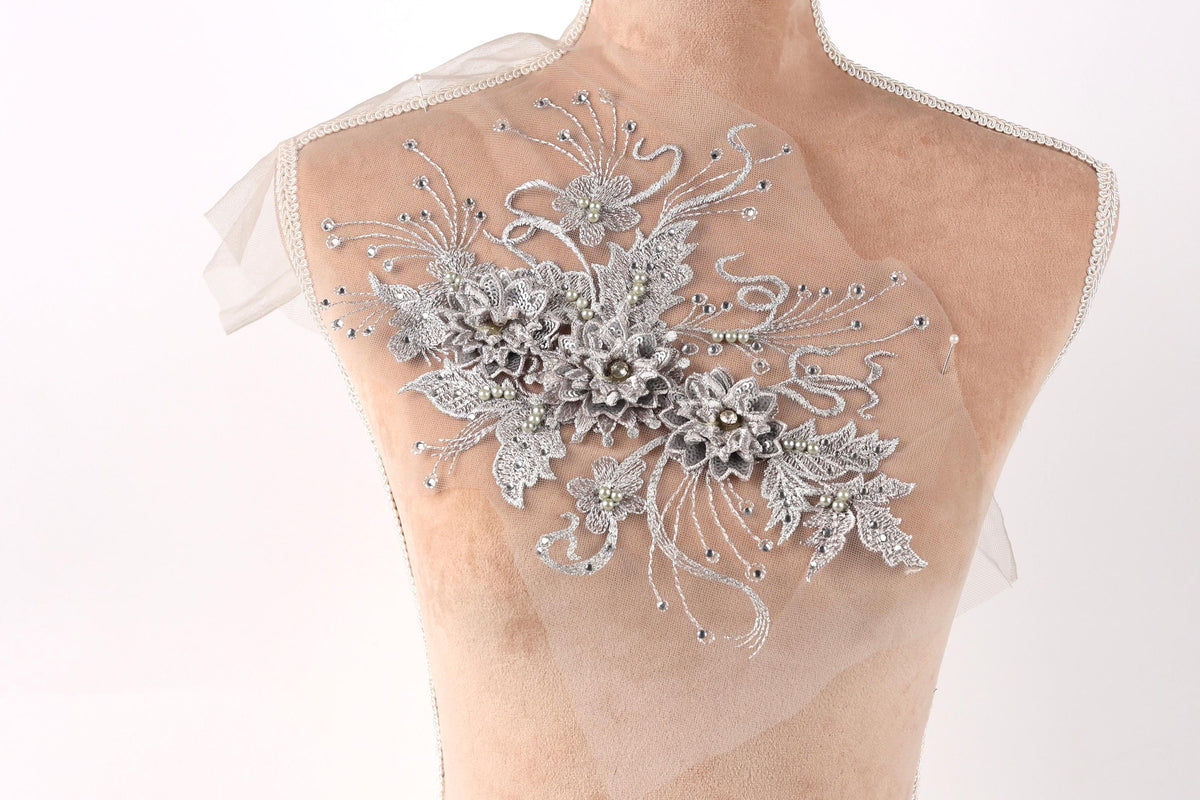 A mannequin with a decorative floral embroidery on its back.