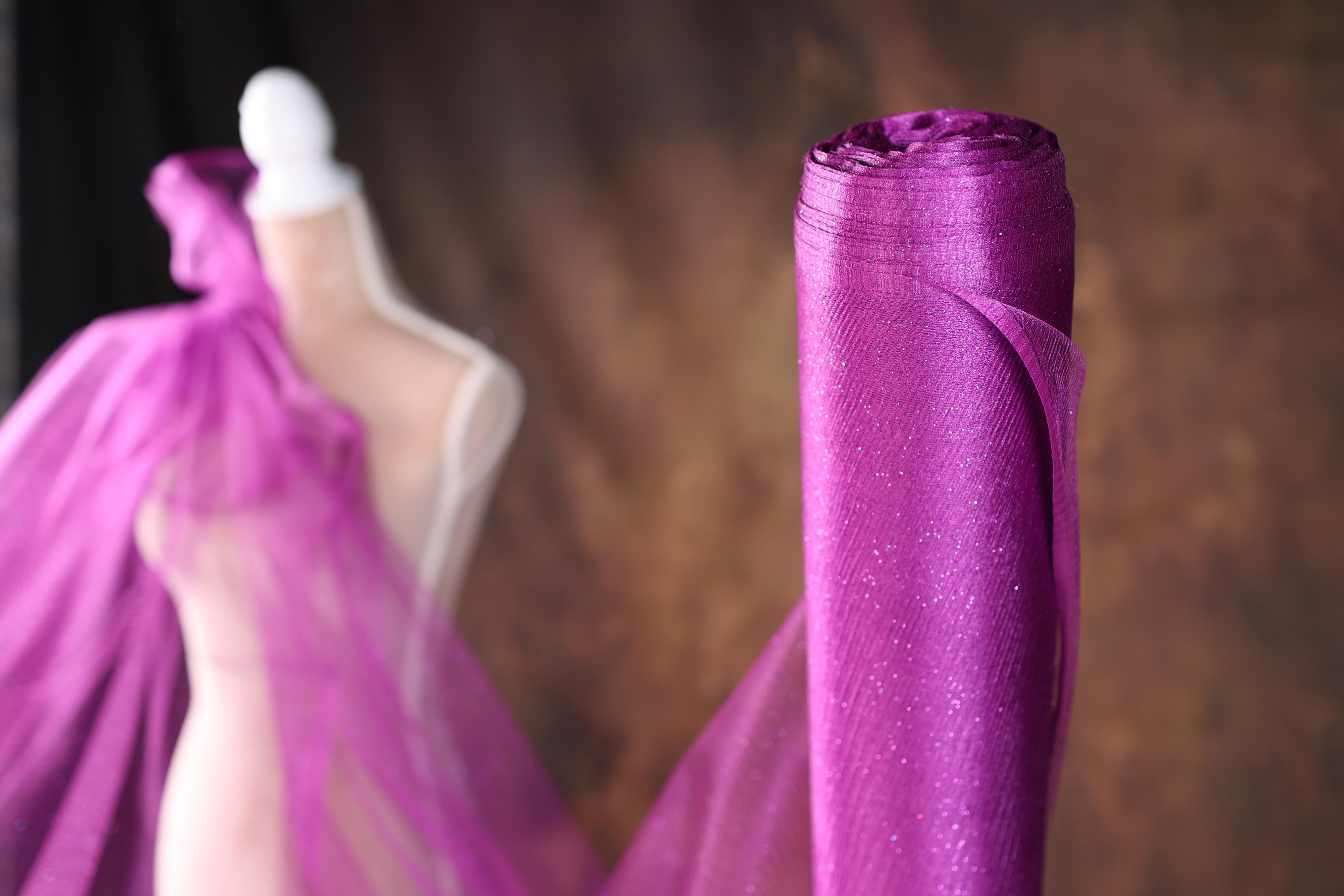 two mannequins dressed in purple tulle and veils