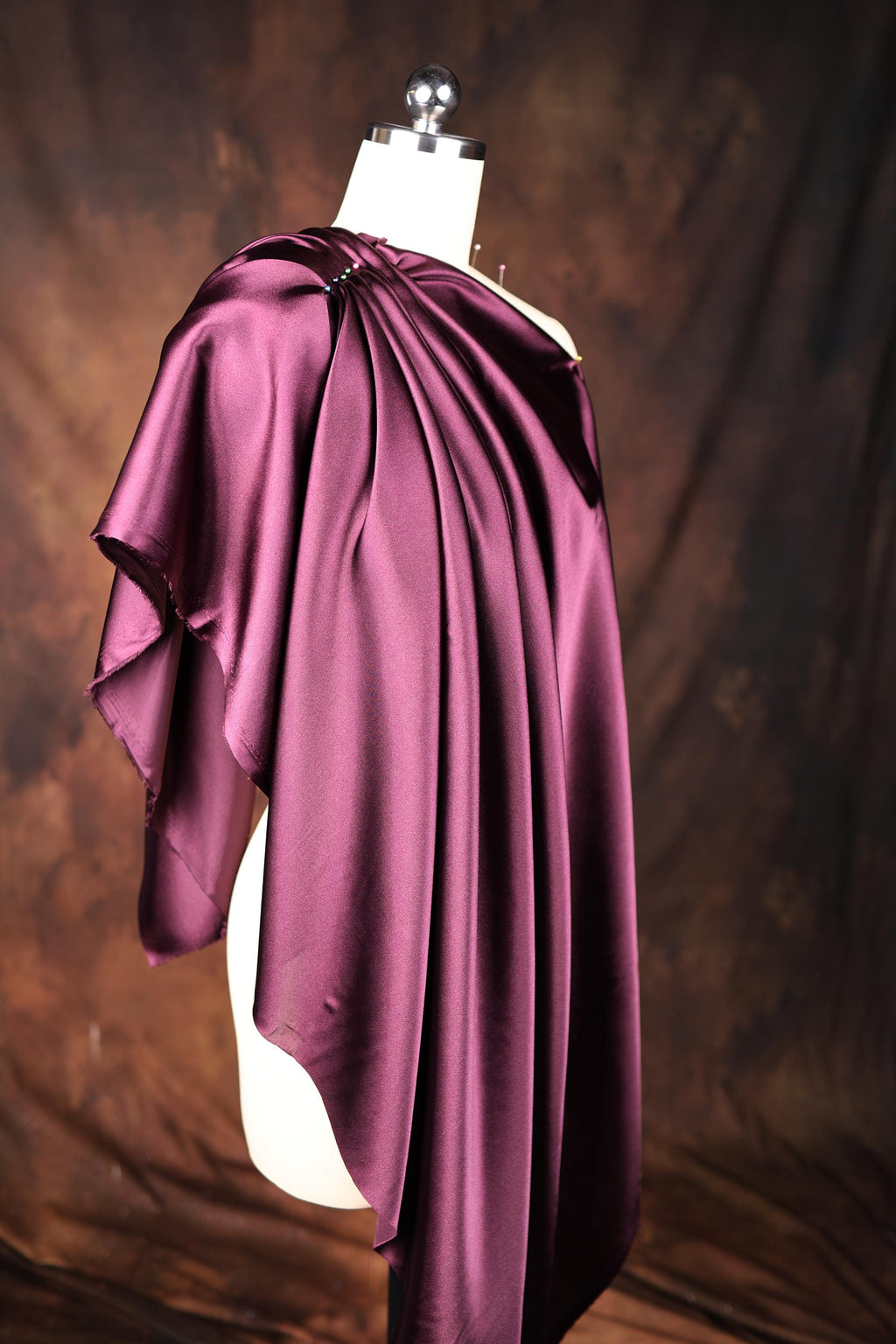a purple cape on a mannequin head