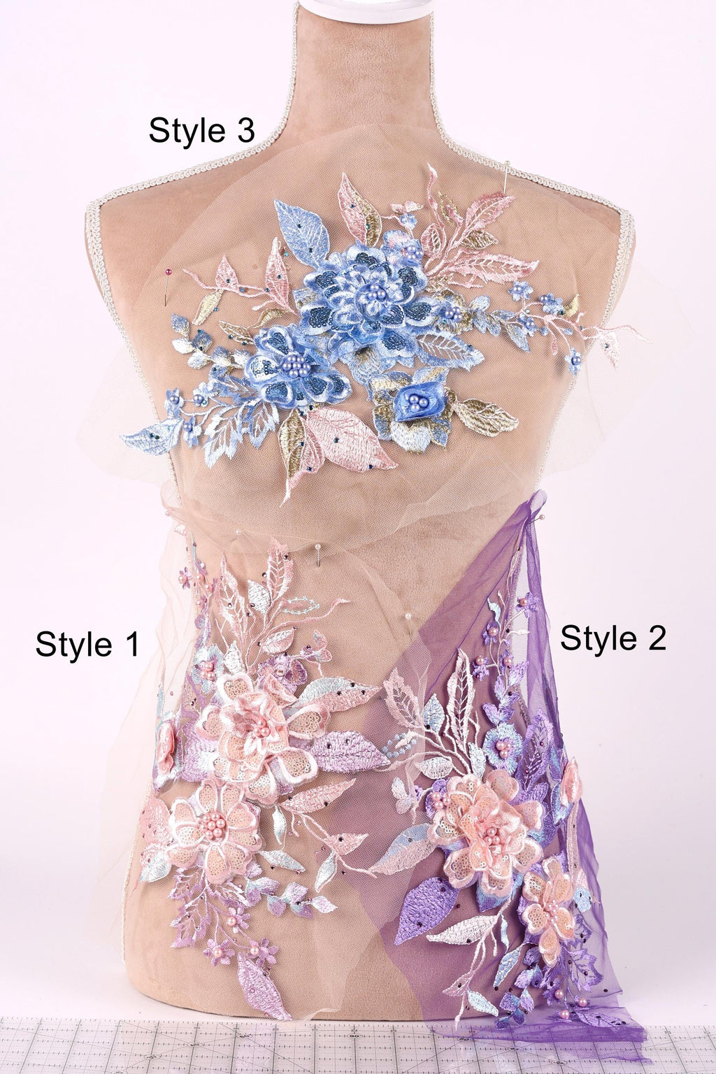 A mannequin with a floral design on its bust, featuring a combination of blue and pink flowers, leaves, and other decorative elements. The mannequin is labeled with the styles "Style 3" and "Style 1" and "Style 2", indicating different designs or patterns.