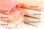 a collection of fabric swatches in various shades of peach, including coral, peach, and champagne.