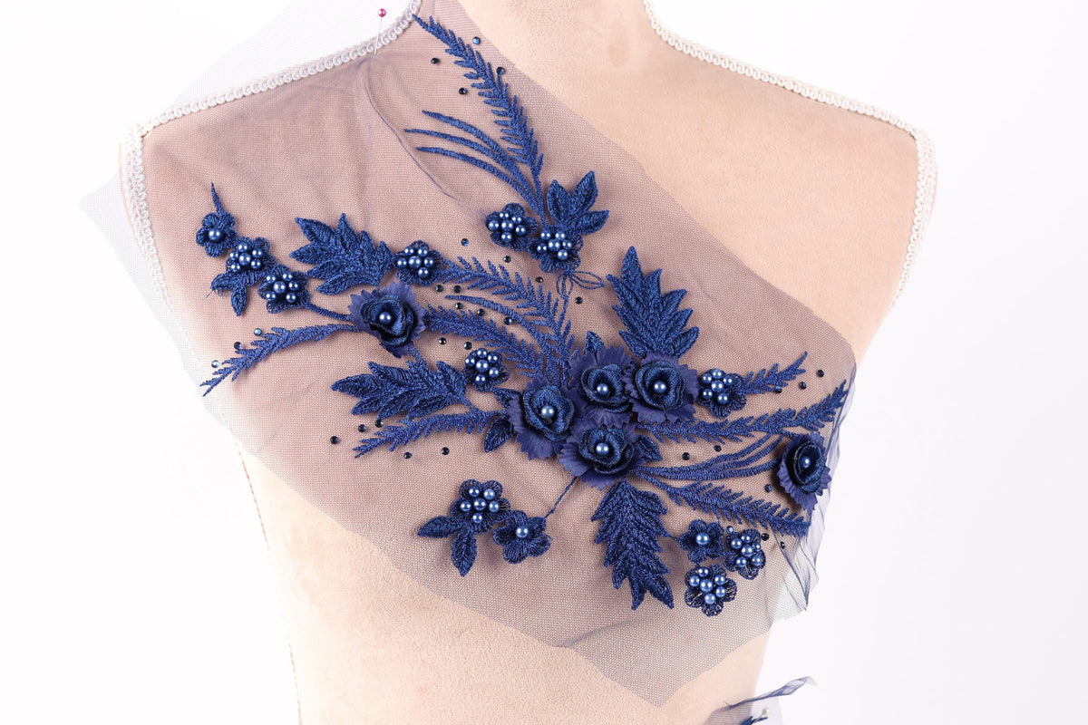 A mannequin torso with a decorative fabric overlay featuring blue floral and leaf patterns.