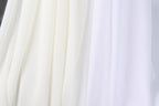 a close-up view of a white fabric, possibly a sheer or sheer-like material, with a subtle texture. The fabric appears to be made of a sheer white material, which could be used for various purposes, such as clothing, home decor, or window treatments. The image does not contain any discernible objects or actions, and the focus is on the fabric's texture and color.