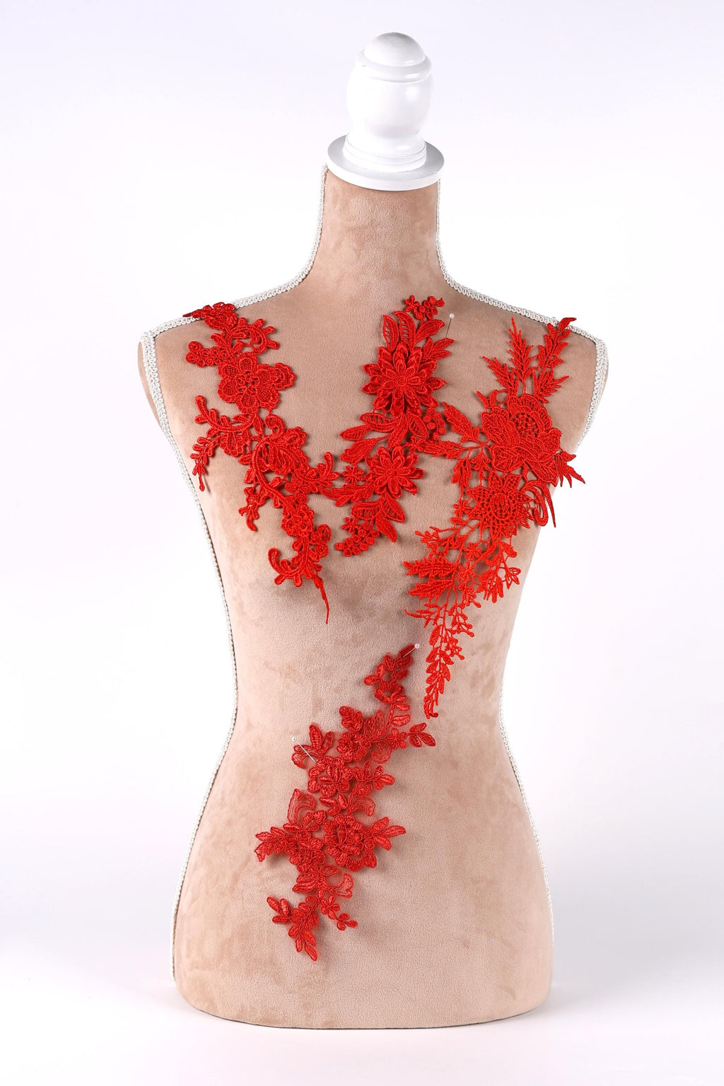 A mannequin with red floral embroidery on its bust and shoulders, displayed against a white background.
