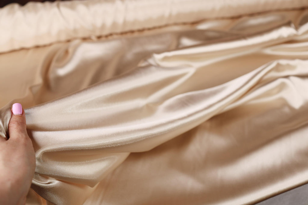 a woman&#39;s hand is holding a piece of fabric