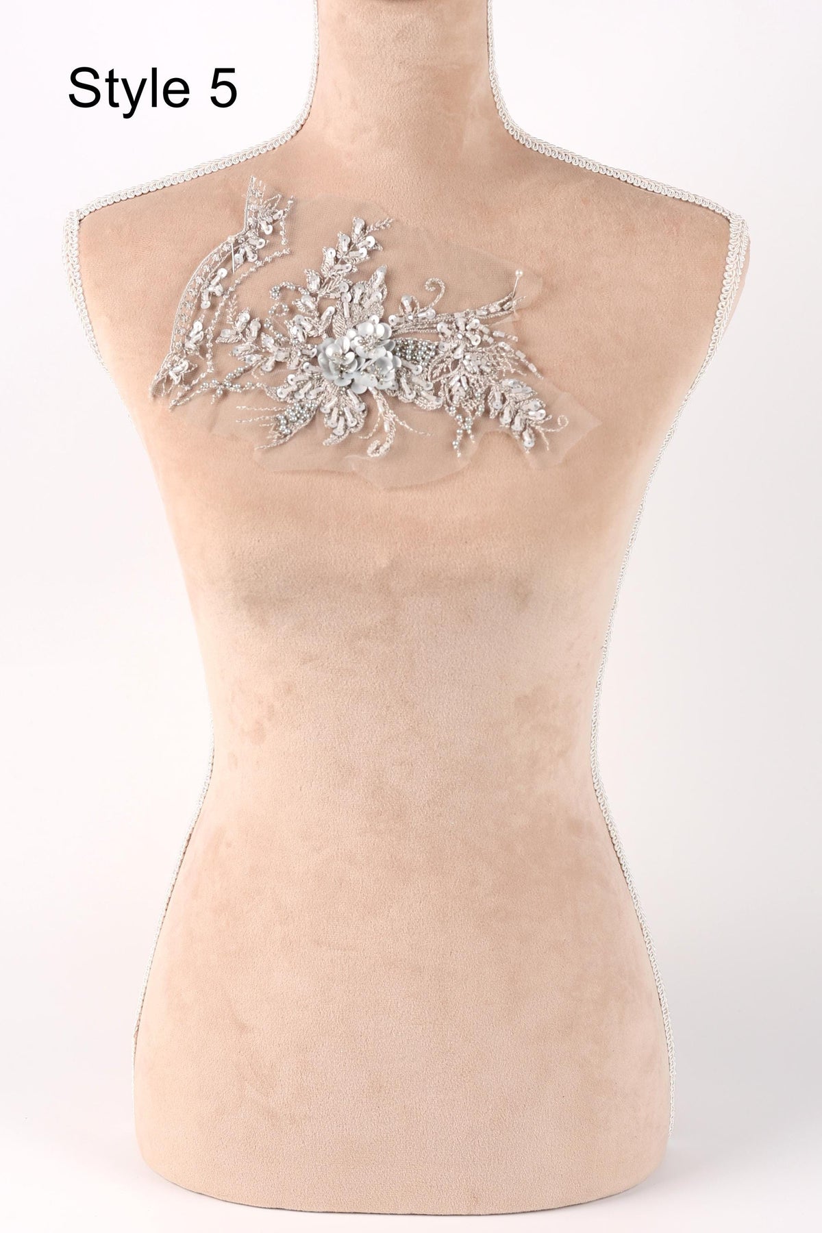 A mannequin with a decorative floral embroidery on its bust.