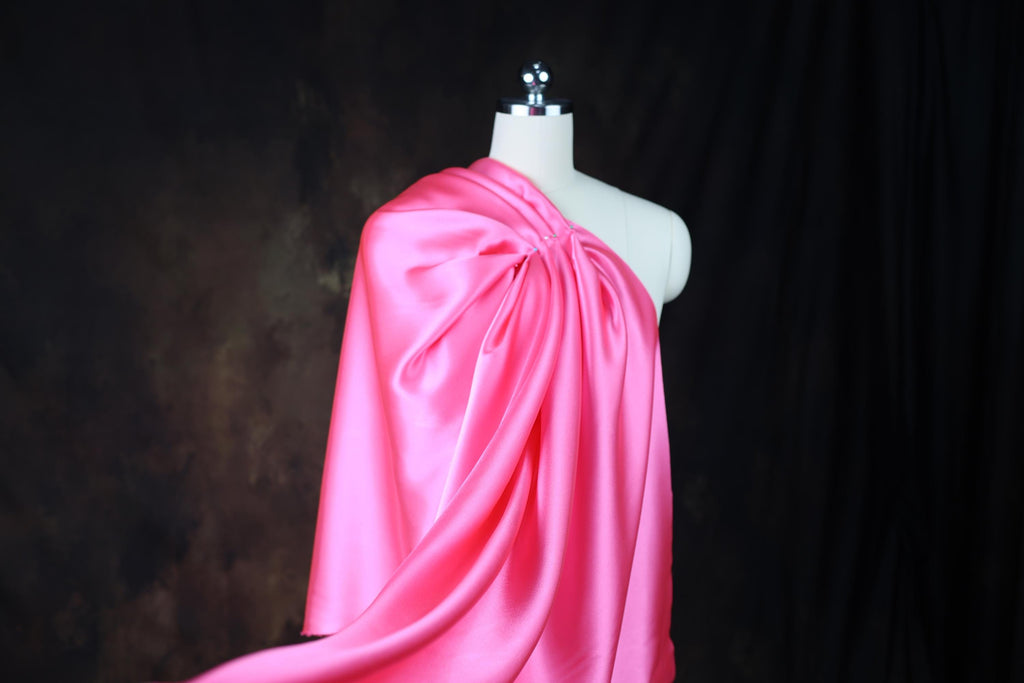 a mannequin dressed in a pink cape