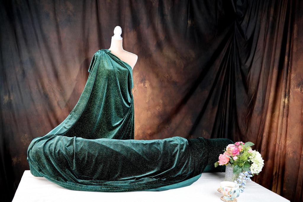 a dress on a mannequin on a table with a vase of flowers