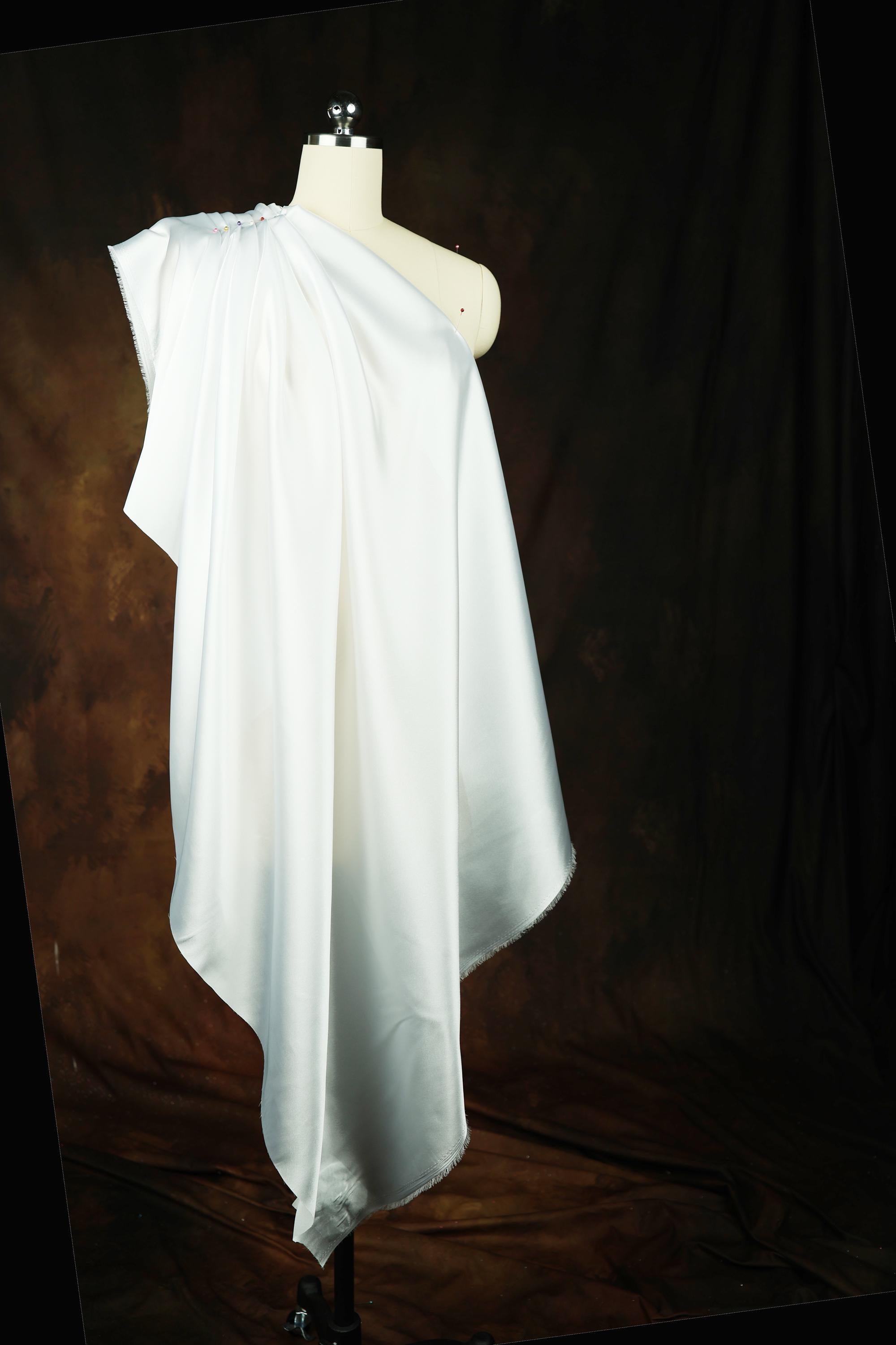 a white dress on a mannequin on a black background