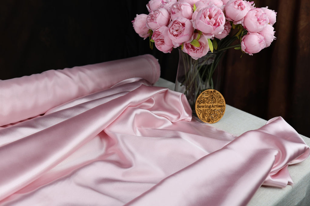 a vase filled with pink flowers on top of a table