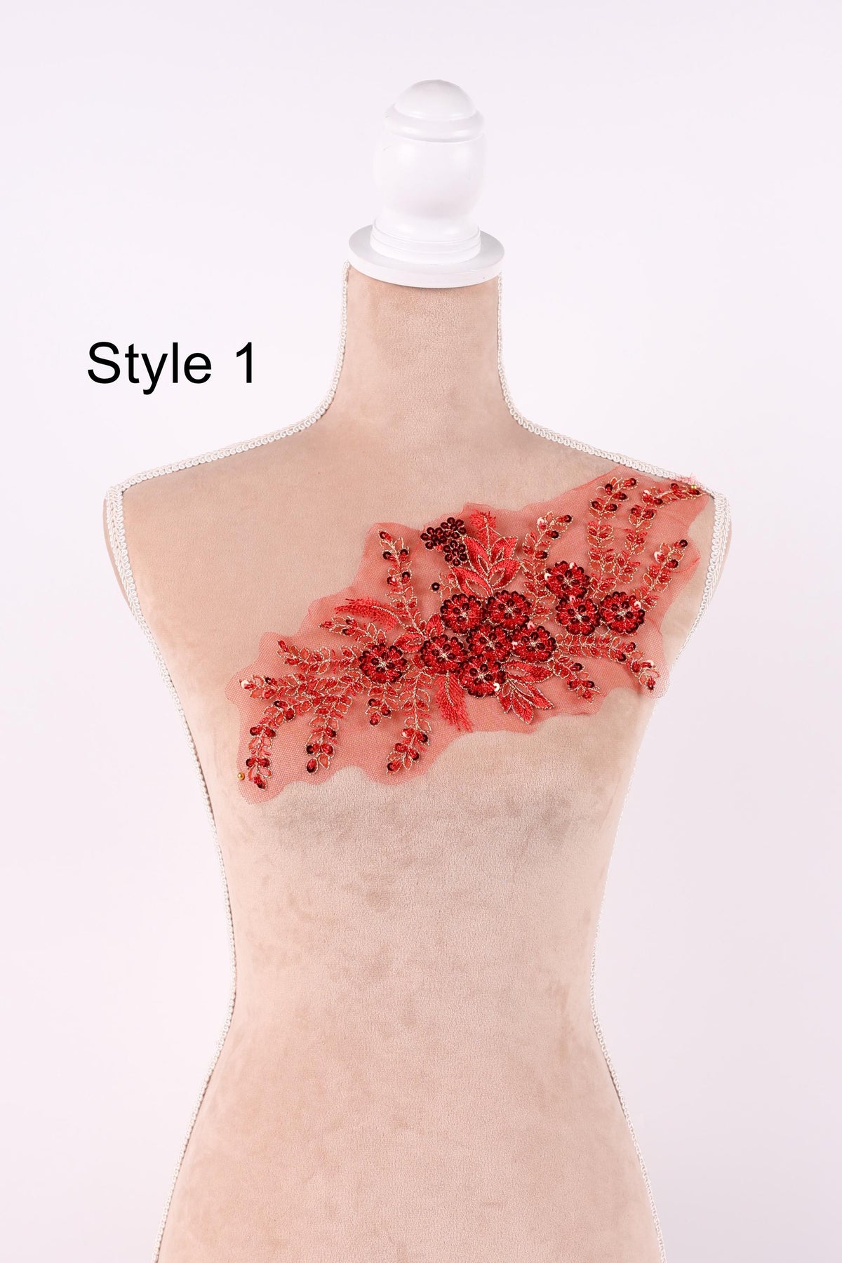 A mannequin with a red floral embroidered patch on its chest.