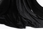 a close-up view of a black velvet fabric with a sparkly texture, creating a shiny and luxurious appearance.