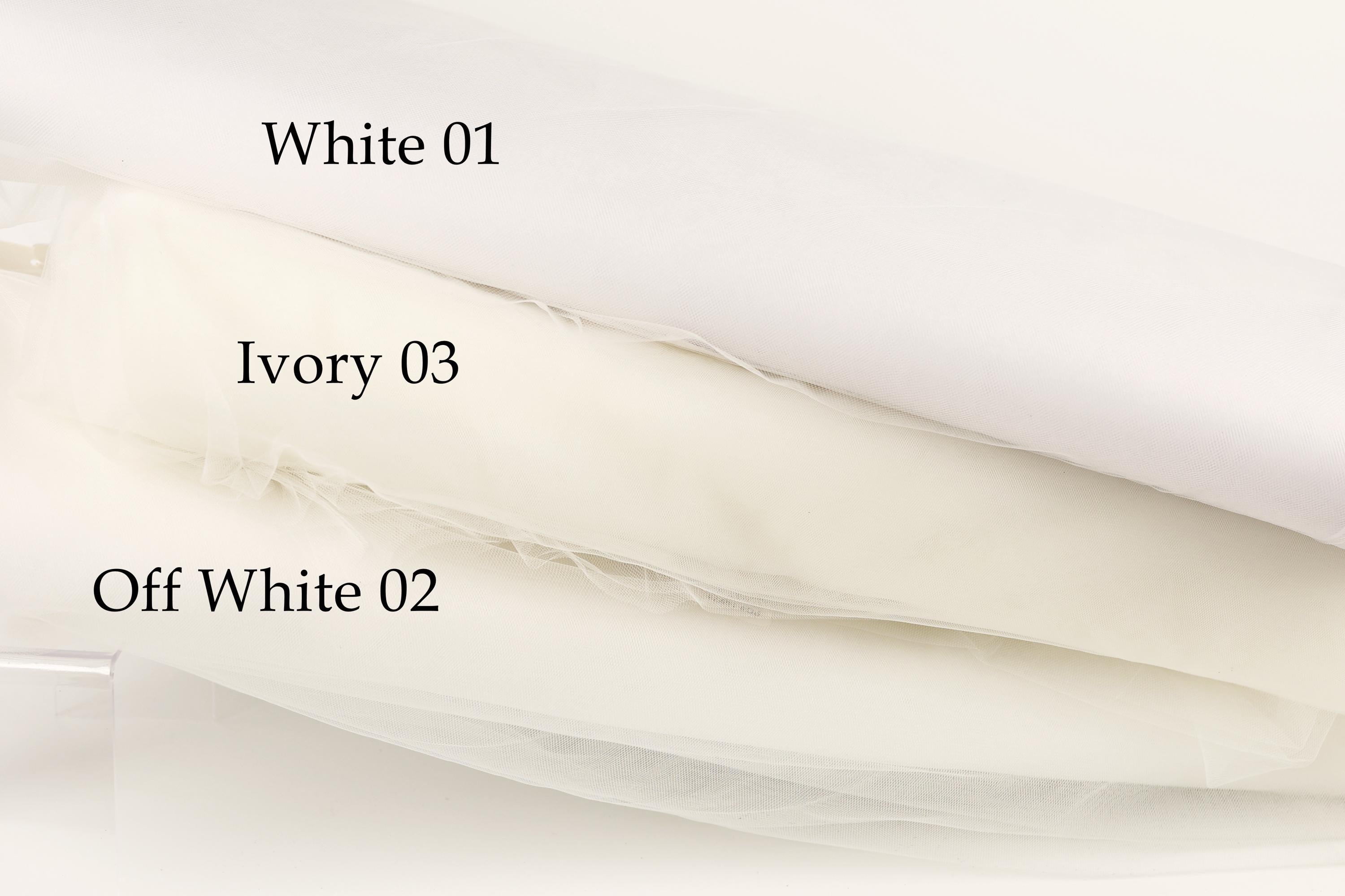 three different shades of white fabric, each labeled with a number.