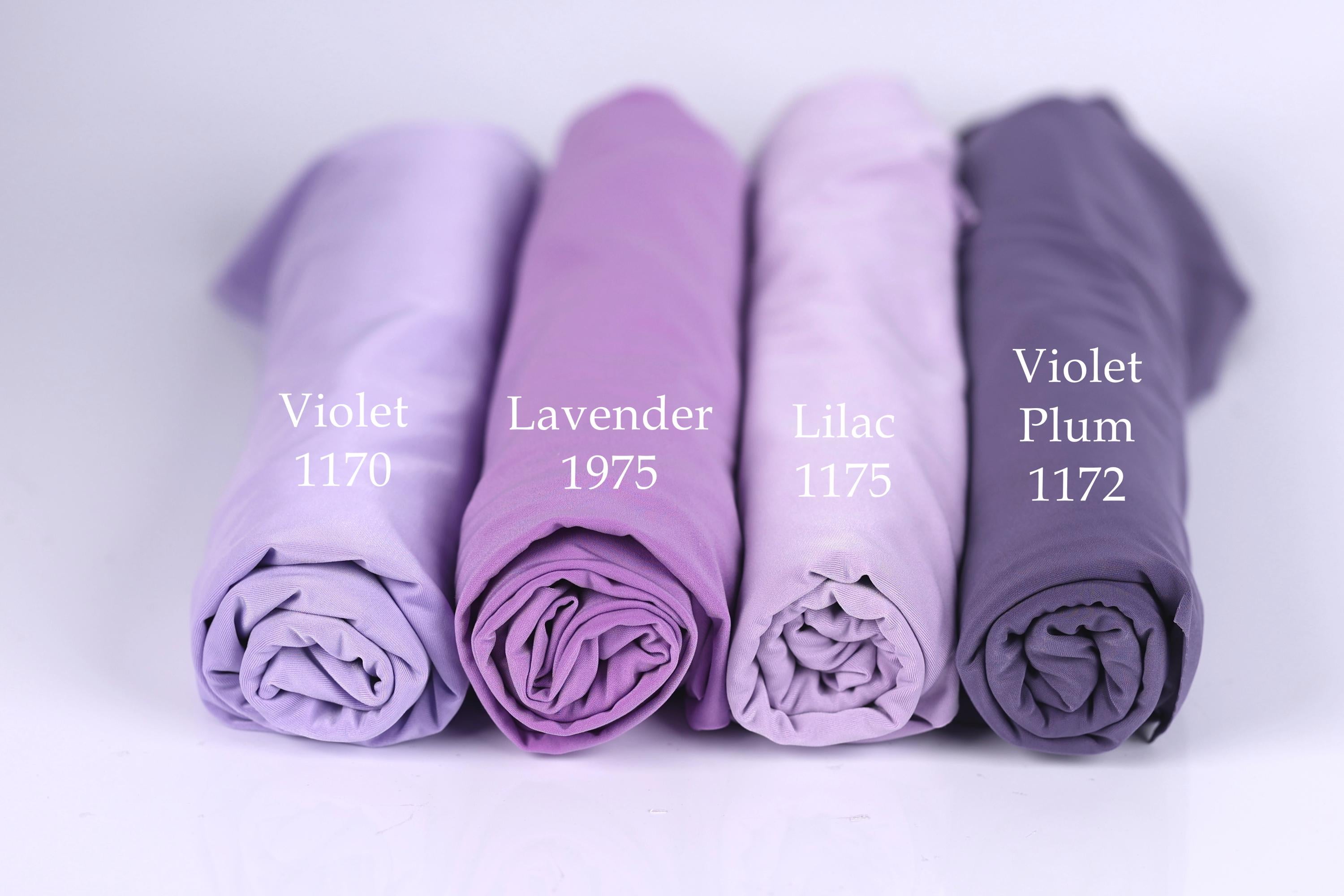 Four rolled-up fabric swatches in different shades of purple, labeled with the names of the colors: Violet, Lavender, Lilac, and Plum.