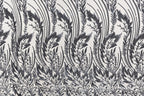 a repeating pattern of black and white floral designs on a fabric surface.