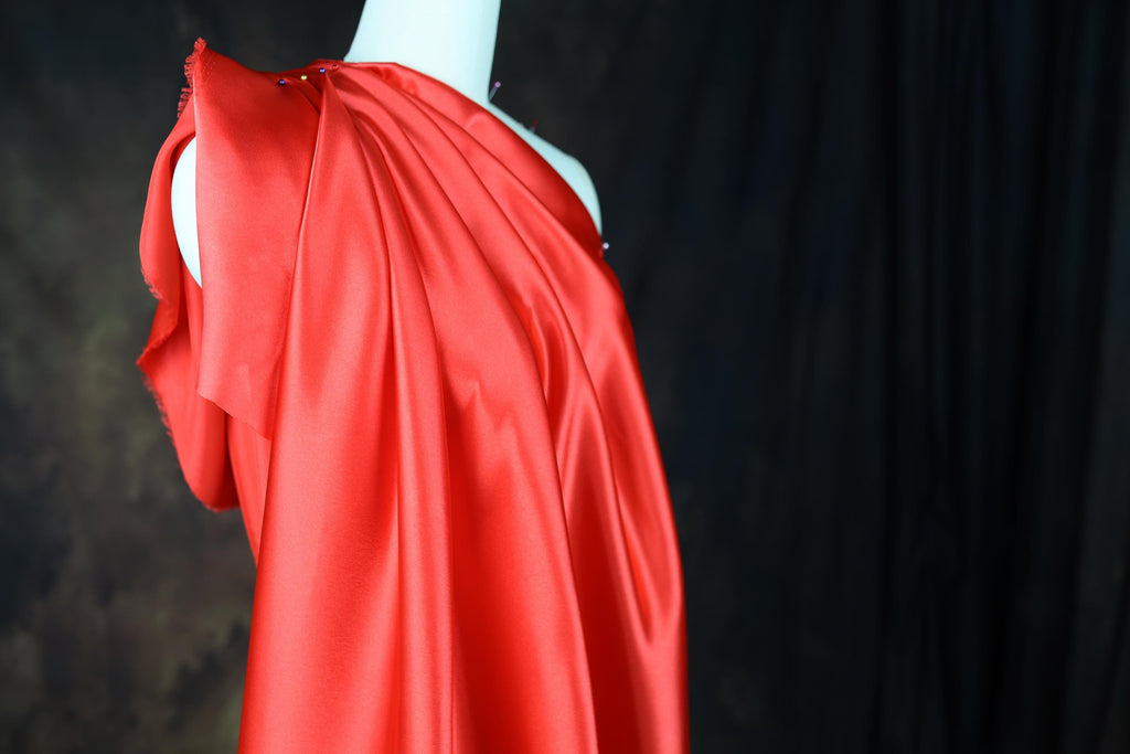 a red dress on a mannequin with a black background