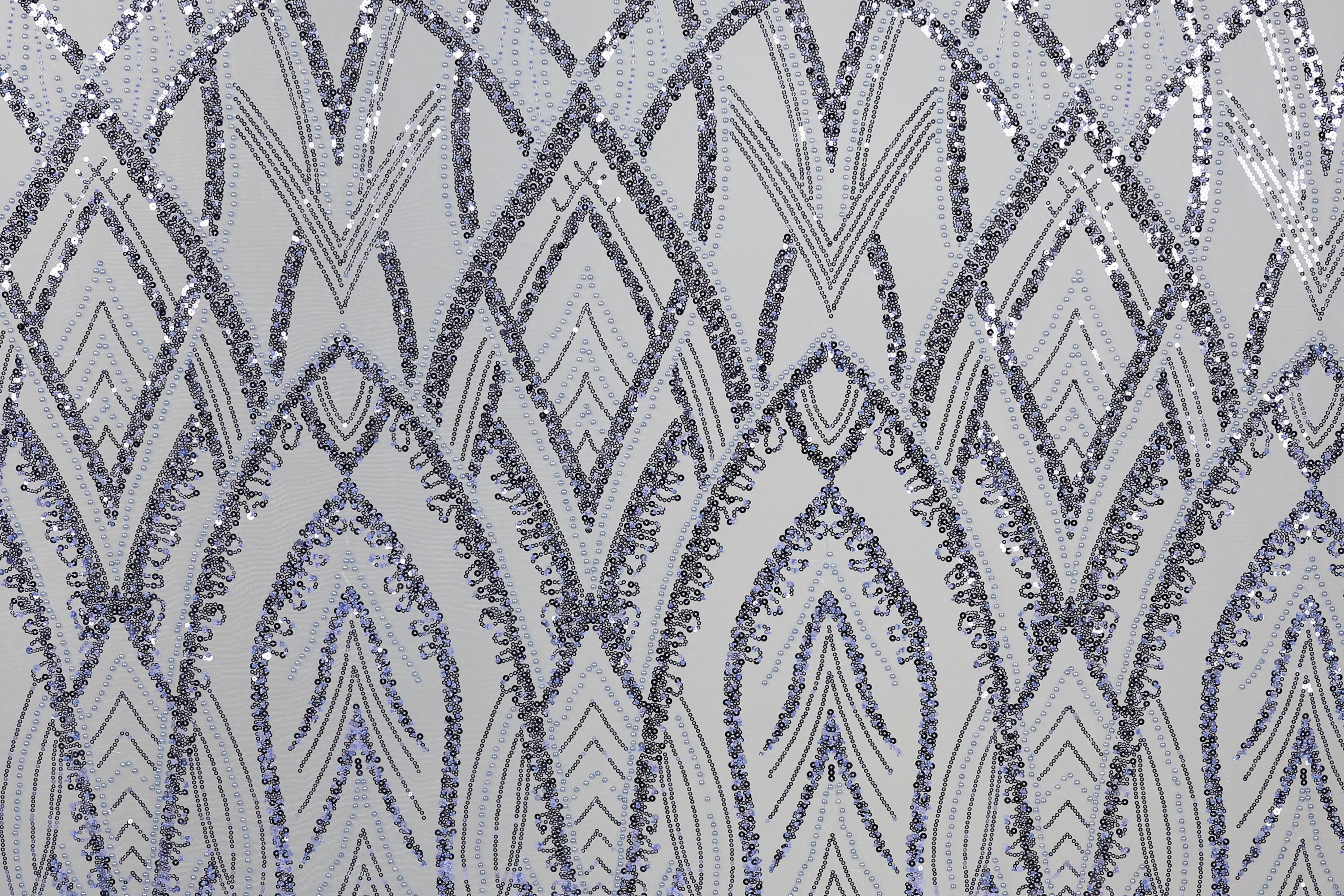 a repeating pattern of diamond-shaped sequins in shades of blue and gray, creating a visually striking and intricate design.