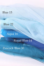 a stack of different colored tulle fabric, including Blue 15, Blue 22, Aqua 16, Royal Blue 14, and Peacock Blue 30, arranged in a visually appealing manner.