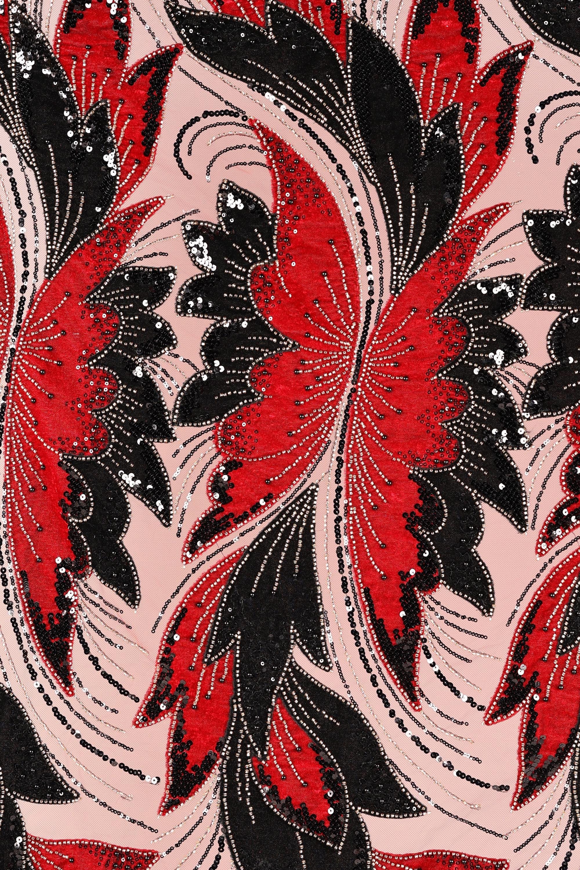 a repeating pattern of red and black butterfly-like shapes with intricate designs and sequins, creating a visually striking and vibrant textile or fabric design.