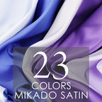 The image is a close-up of a fabric with a gradient of colors, including shades of blue, purple, and white. The text "23 COLORS MIKADO SATIN" is displayed prominently in the center of the image.