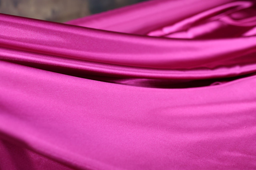 a close up of a pink satin material