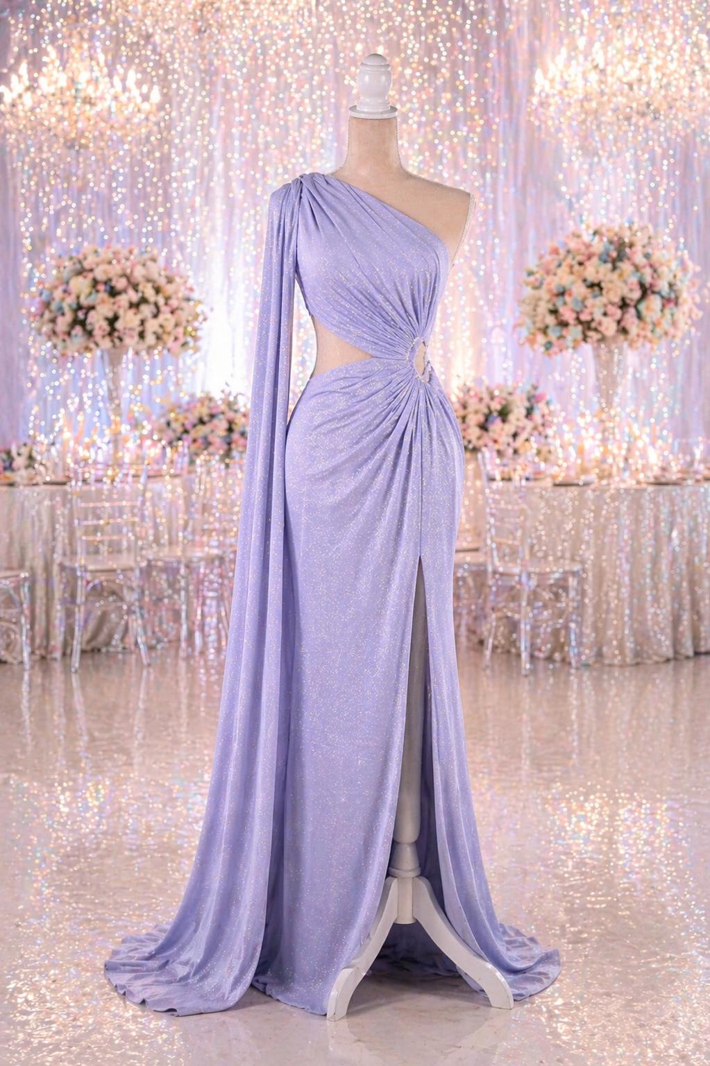 A lavender one-shoulder gown with a long train and a high slit on the side, displayed on a mannequin in a room with a floral backdrop.
