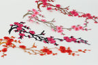 various floral designs, including branches with pink flowers and black branches with red flowers. The designs are arranged in a visually appealing manner, showcasing the beauty of the flowers and branches.