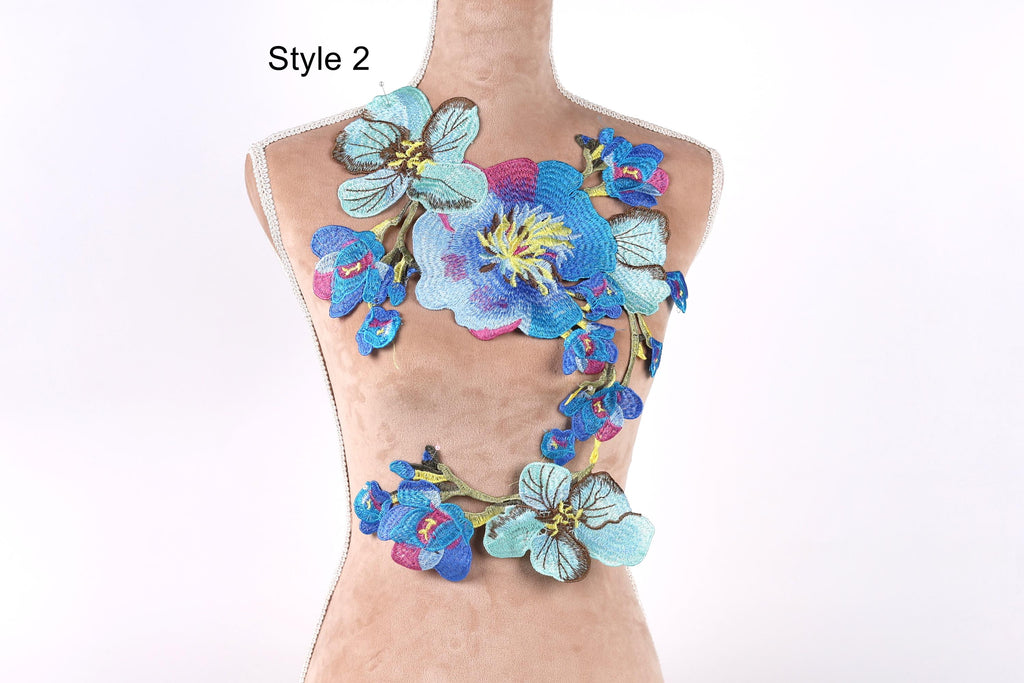 A mannequin wearing a colorful floral embroidered patch on its chest.