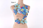 A mannequin wearing a colorful floral embroidered patch on its chest.