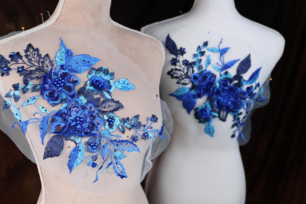 two mannequins with blue flowers on them