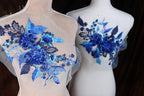 two mannequins with blue flowers on them