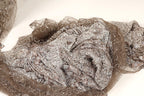 a close-up view of a piece of fabric with a brown and silver pattern, possibly a lace or chiffon material.