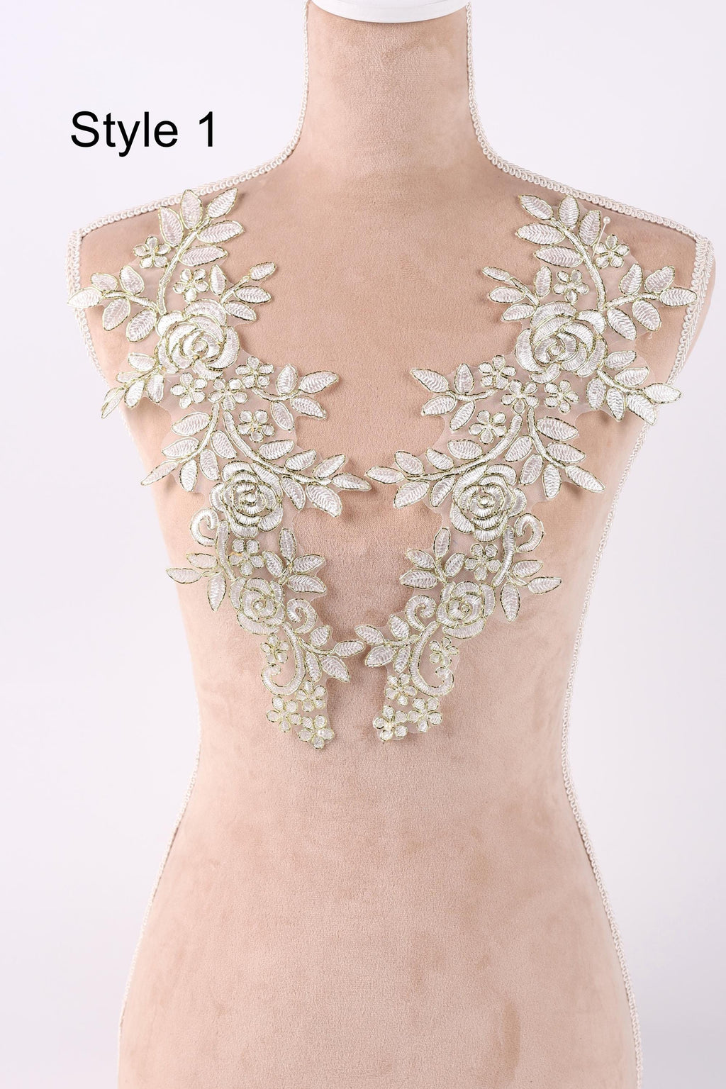 A mannequin wearing a dress with a floral lace overlay.