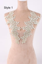 A mannequin wearing a dress with a floral lace overlay.
