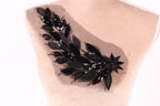 a close-up view of a mannequin torso with a decorative black sequin and leaf-like embellishment on the back.