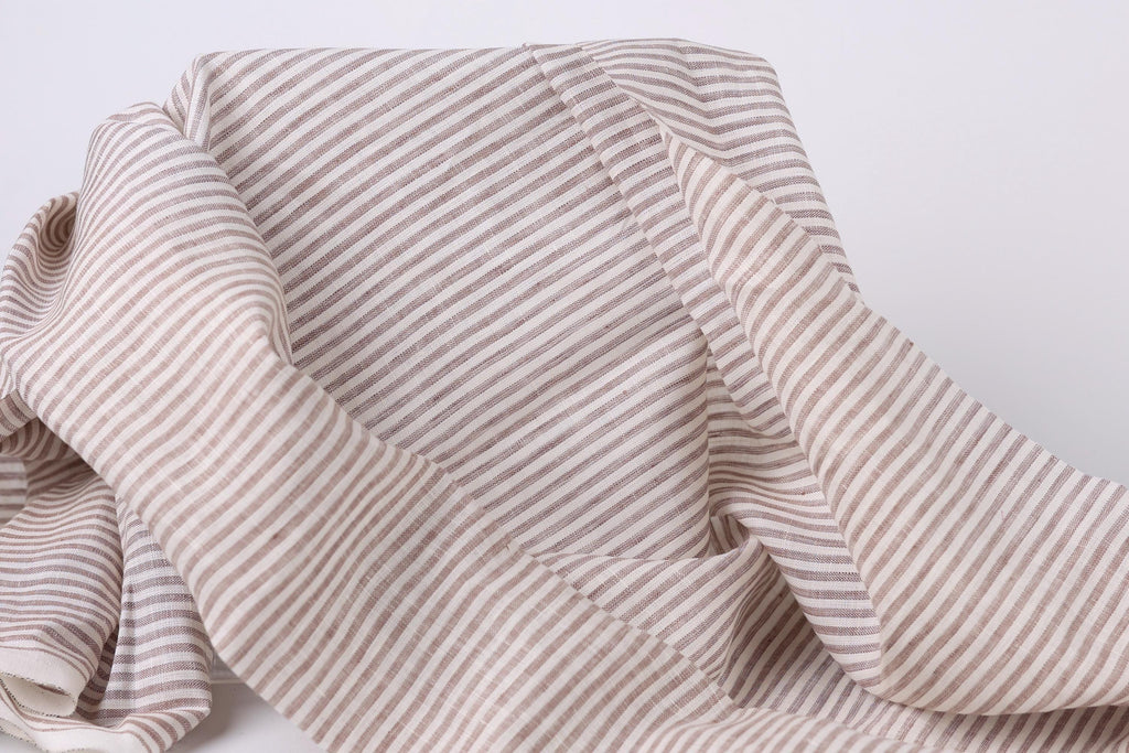 A close-up view of a fabric with horizontal stripes in various shades of brown and beige.