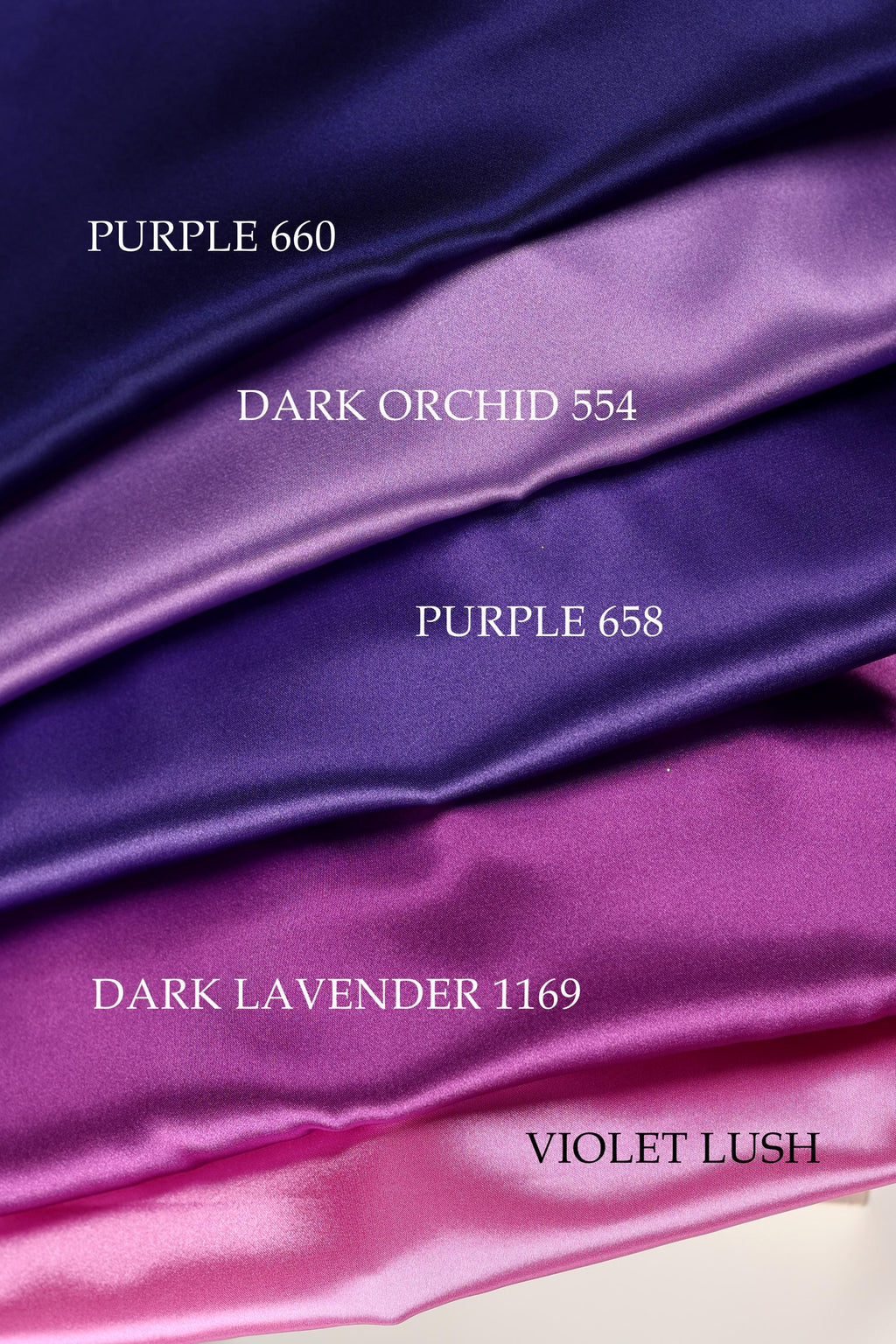 a collection of fabric swatches in various colors, including purple, dark purple, and pink.