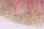 a close-up view of a delicate, pink tulle skirt with intricate gold embroidery and sequins.