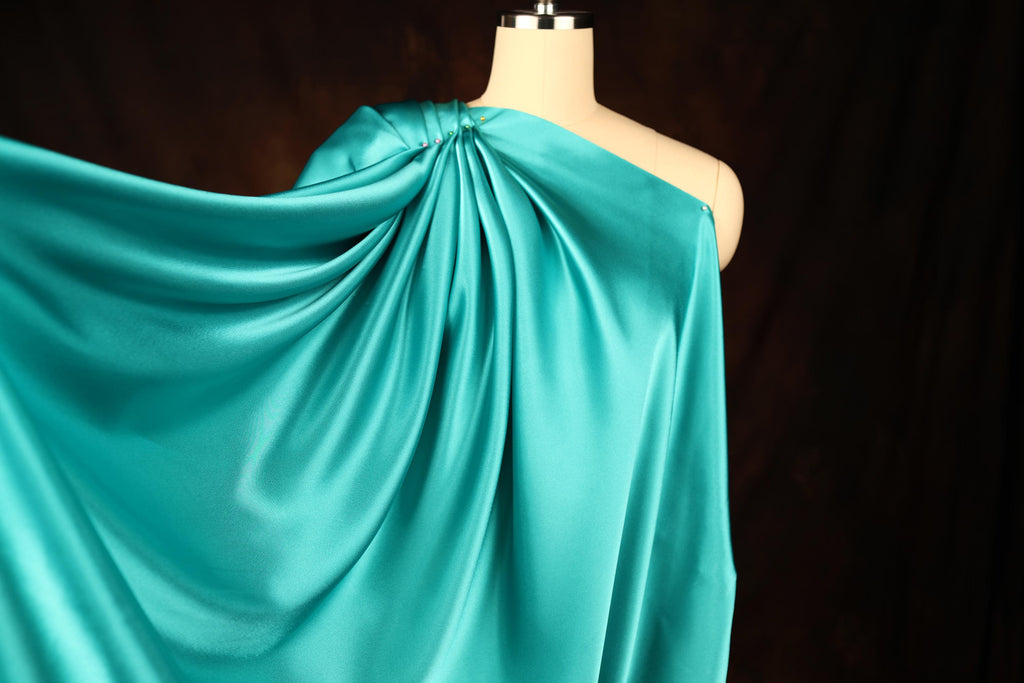 a dress on a mannequin with a blue cloth draped over it