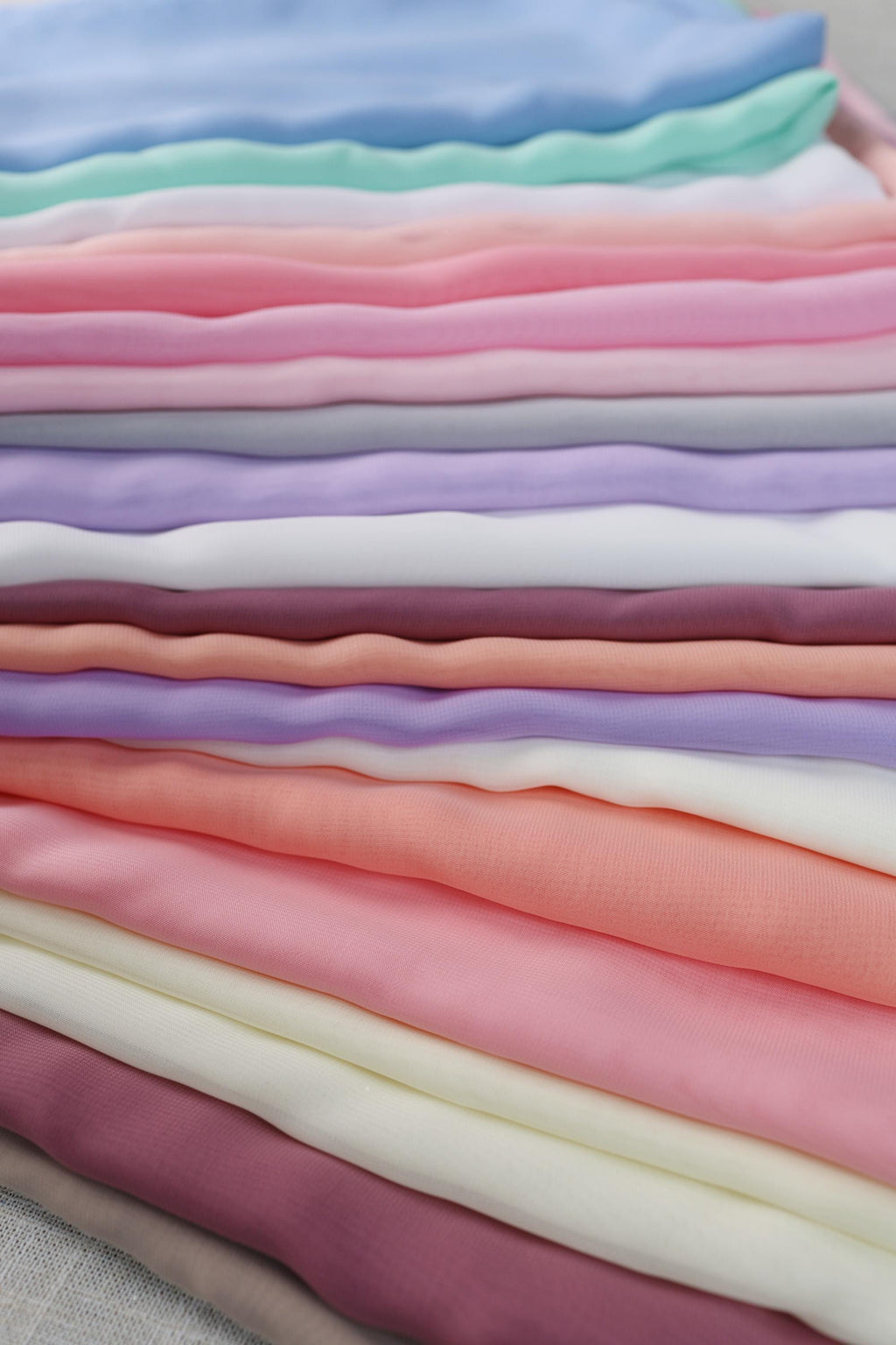 a pile of different colored fabric on a table