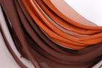 a close-up view of a fabric with a mix of brown and orange colors, creating a visually appealing and textured appearance.
