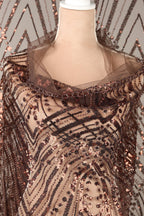 a mannequin wearing a brown sequin dress with a sheer overlay.