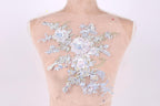 A mannequin torso with a delicate floral embroidered patch on the back.