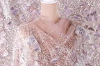 a mannequin wearing a pink and white sequined dress with a sheer, tulle-like fabric draped over it.