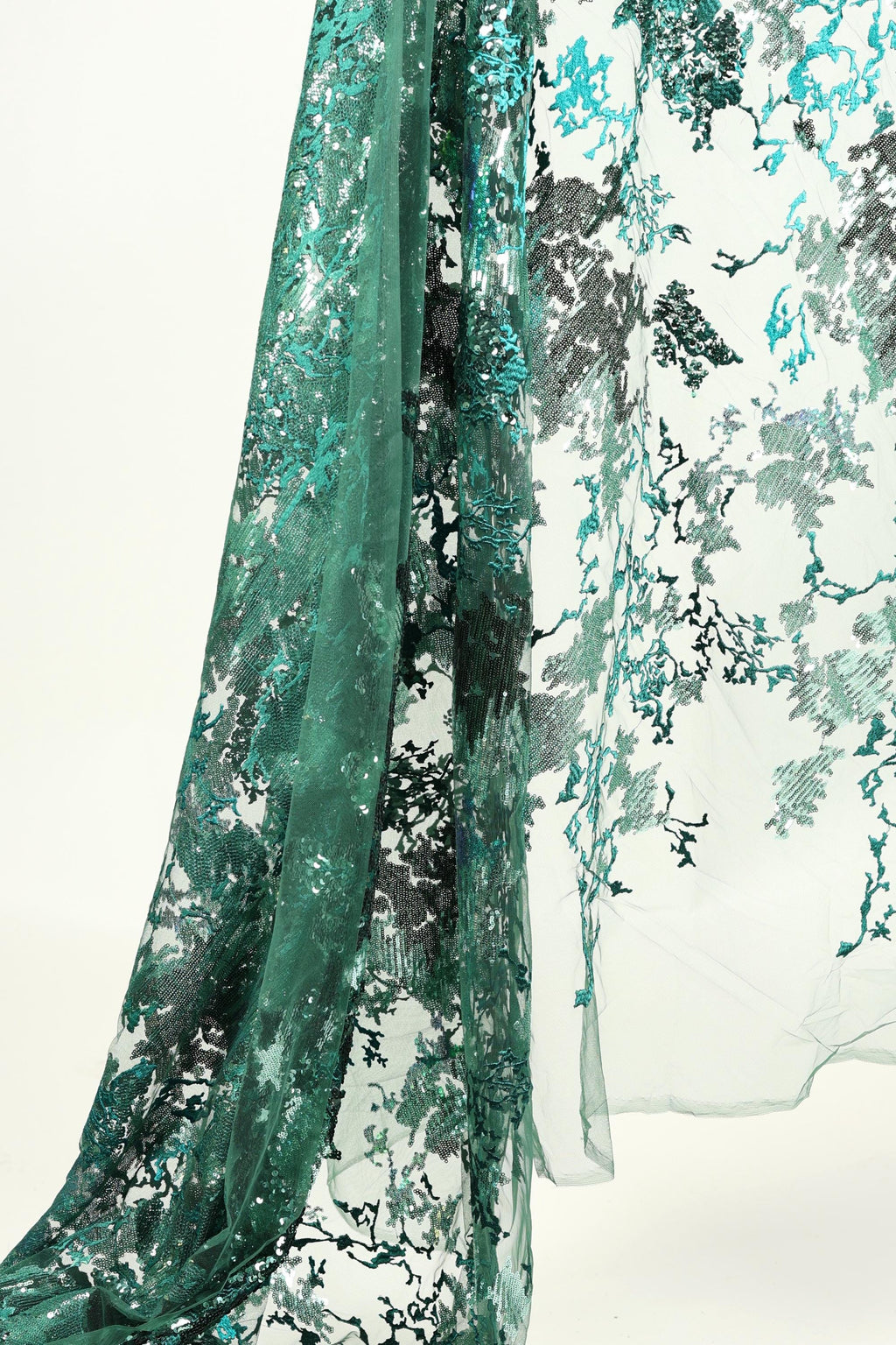 a close-up view of a fabric with a floral pattern in shades of green and black.