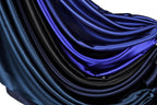a close-up view of a fabric with a gradient of blue and black colors, creating a visually striking and textured appearance.