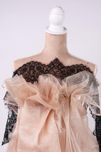 A mannequin wearing a dress with a lace bodice and a sheer, ruffled skirt.
