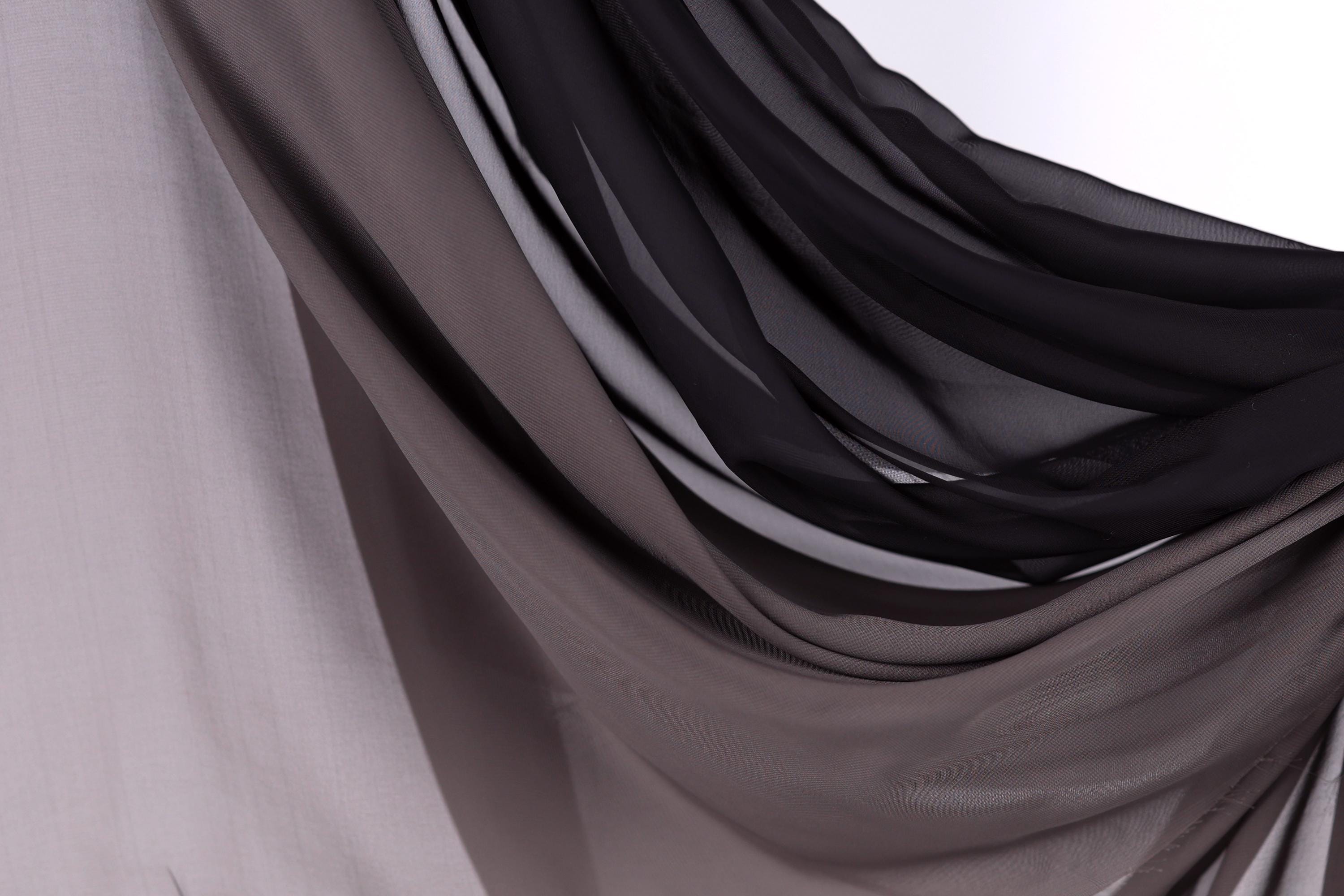 a close-up view of a fabric with a mix of dark and light gray colors, creating a visually striking contrast.