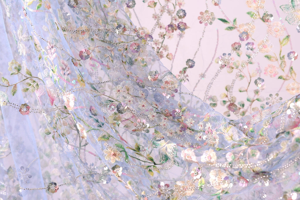 a close up of a sheer curtain with flowers on it