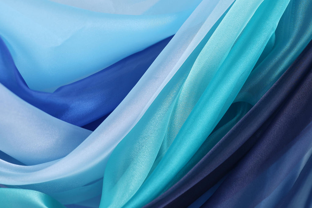 a close-up view of various shades of blue and purple fabric, creating a visually striking and textured composition.